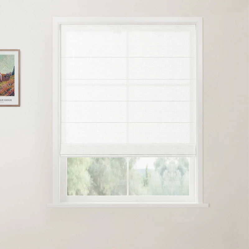 Photograph of an interior room showcasing a white window fitted with a translucent Roman blind partially open to a lush green outdoor view, with a framed Van Gogh landscape print on the adjacent light-colored wall