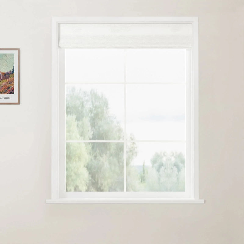 Photograph of a white window with a light grey roller blind revealing a blurred outdoor scene of green trees and light sky, alongside a framed Van Gogh art print on a light beige wall