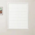 Photograph of a white framed window featuring a clean white horizontally folded Roman blind on a light beige wall with a framed Van Gogh print visible on the left