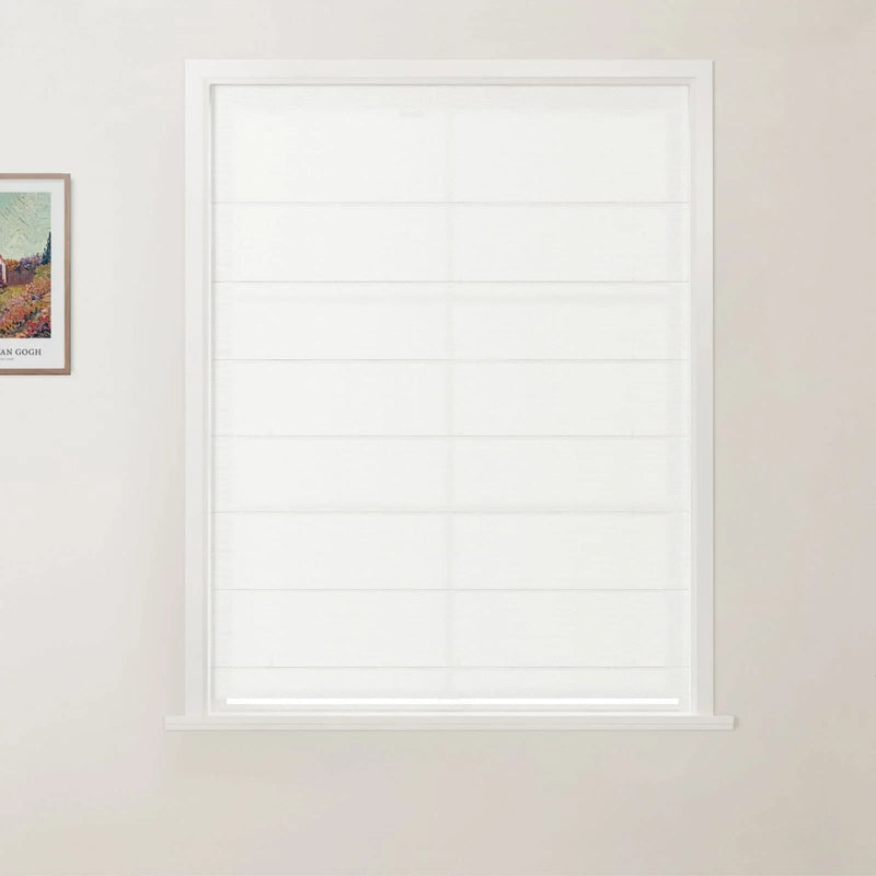 Photograph of a white framed window featuring a clean white horizontally folded Roman blind on a light beige wall with a framed Van Gogh print visible on the left