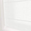 A pure white fabric Roman window blind with a subtle woven texture and gentle horizontal folds filtering light in a modern interior