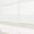 White textured fabric window shade with a subtle grid pattern and a clear translucent plastic pull tab