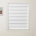 Photograph of an interior room featuring a window with white fabric pleated Roman blinds and a framed Van Gogh Arles landscape print on the subtle beige wall