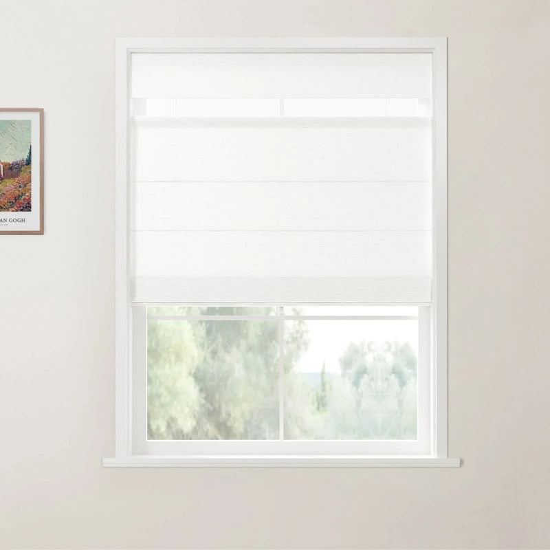 Photograph of an interior window with a white layered roman shade above a view of verdant trees, next to a framed Van Gogh print featuring colorful fields on a light-colored wall