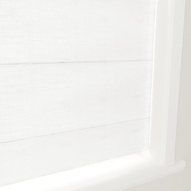 White fabric Roman shades with subtle texture and clean horizontal folds, installed in a bright white window frame and sill