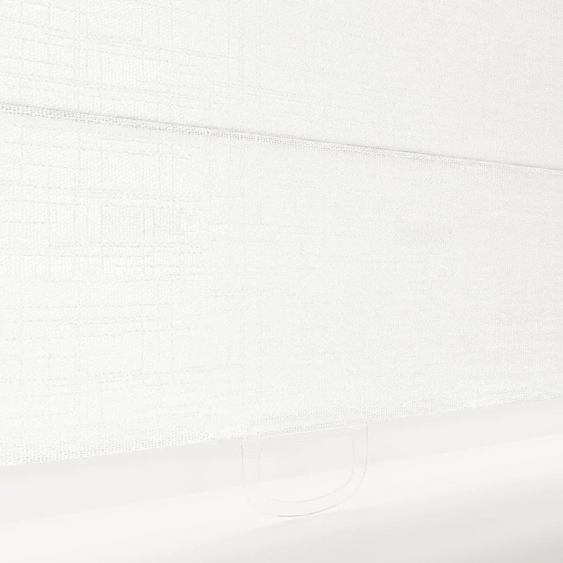 A crisp white textured fabric Roman blind displaying a subtle grid pattern and a clear plastic handle loop