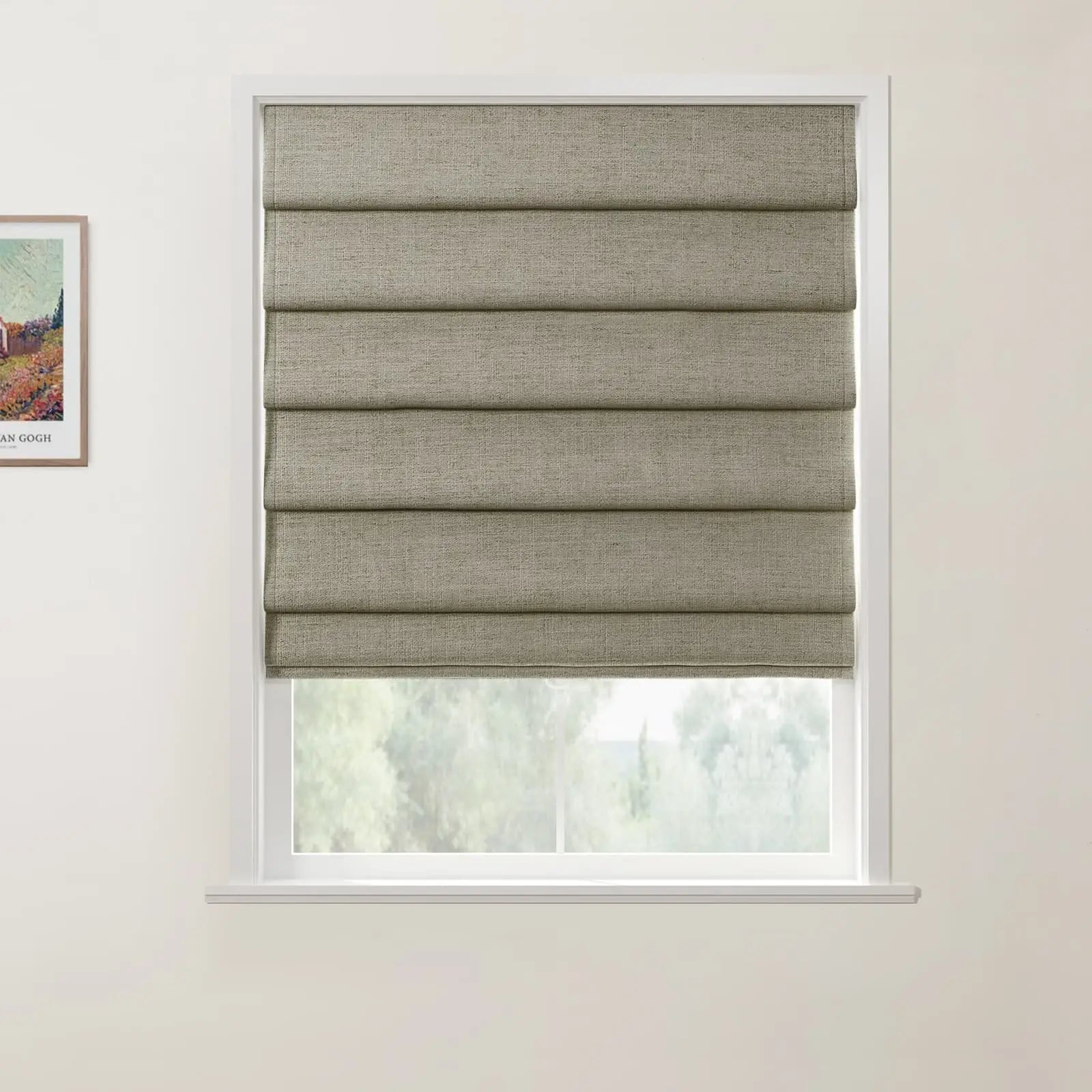 An interior window featuring a textured taupe Roman blind with neat horizontal folds, a crisp white frame, a soft green outdoor view, and a framed Van Gogh landscape print on the left wall