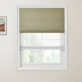 Photograph of a window with a green top-down bottom-up Roman shade and a sheer lower section, next to a framed Van Gogh landscape print, showing blurred trees outside