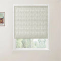 An interior scene featuring a white window frame with a light grey textured Roman blind, partially lowered to reveal green outdoor foliage, and a framed Van Gogh landscape print on the left wall depicting colorful fields and a small house