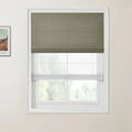 Photograph with a Van Gogh print, depicting a window with an olive green textured Roman shade and a sheer white bottom-up shade revealing a blurred green landscape on a light beige wall