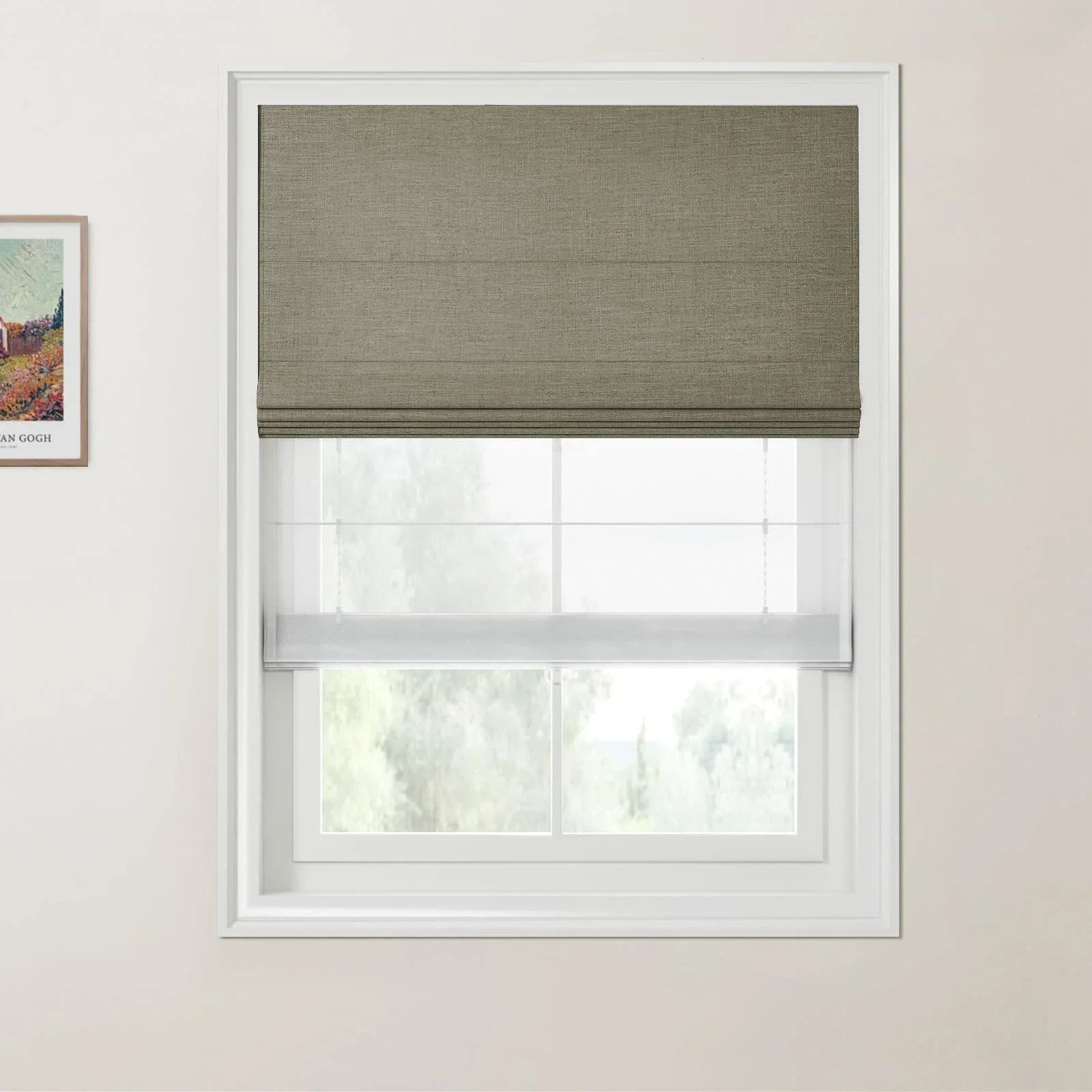 Photograph with a Van Gogh print, depicting a window with an olive green textured Roman shade and a sheer white bottom-up shade revealing a blurred green landscape on a light beige wall