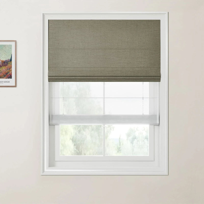 Photograph with a Van Gogh print, depicting a window with an olive green textured Roman shade and a sheer white bottom-up shade revealing a blurred green landscape on a light beige wall