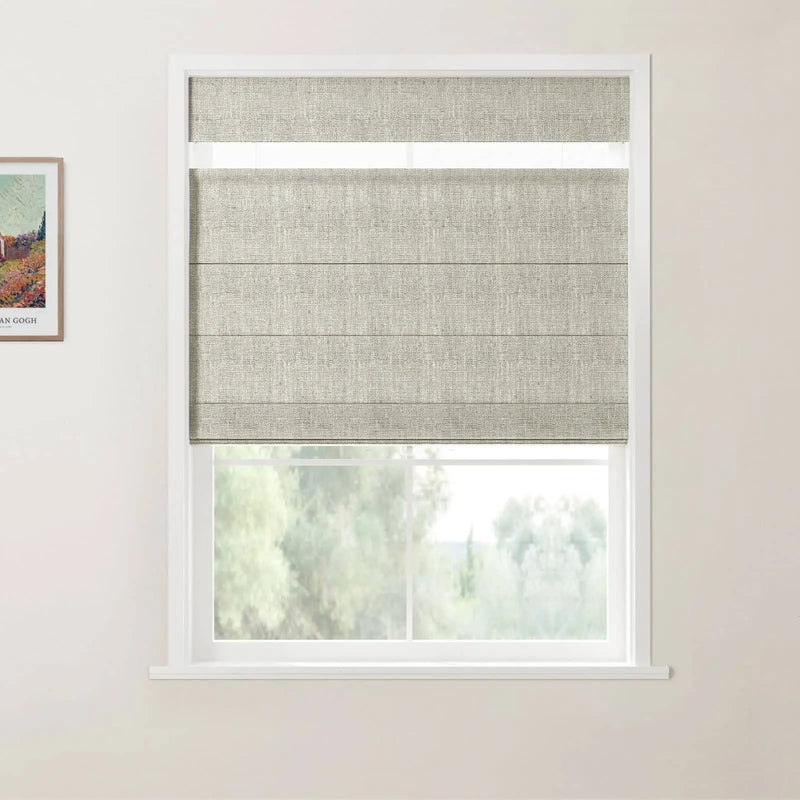 Photograph of an interior with a white-framed window showcasing light beige textured Roman blinds partially open to blurred green trees and a framed Van Gogh print on the left wall