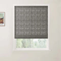 A partially visible colorful print by Van Gogh hangs on the left wall next to a dark grey textured Roman blind covering a white-framed window, offering a soft blurred view of green trees outside