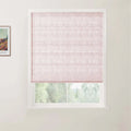 Photograph of an interior with a light pink linen Roman blind covering a white window frame, offering a blurred view of green trees outside, and a colorful framed Van Gogh landscape print visible on the adjacent wall