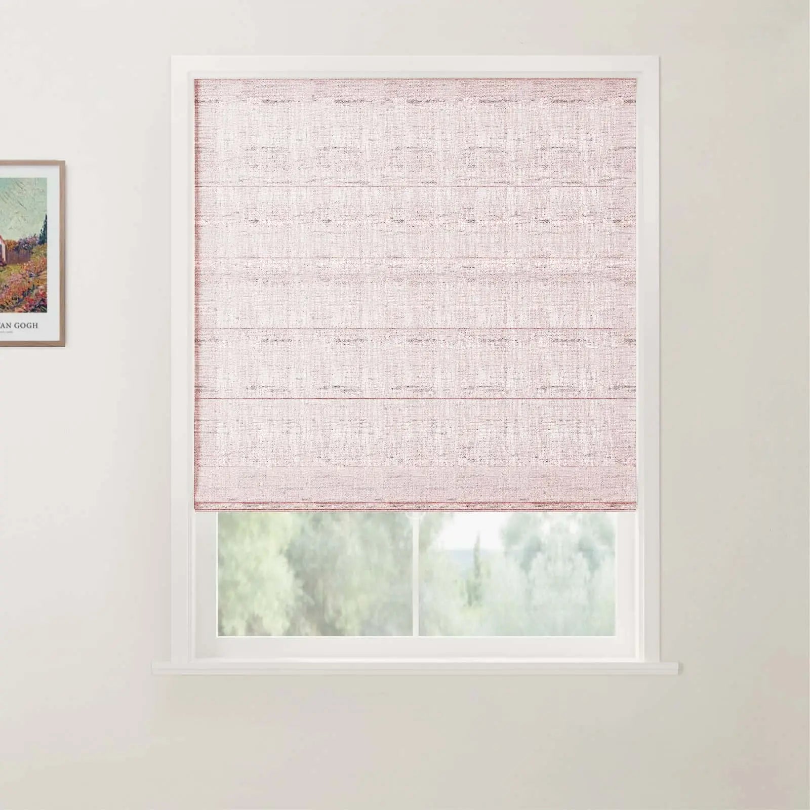 Photograph of an interior with a light pink linen Roman blind covering a white window frame, offering a blurred view of green trees outside, and a colorful framed Van Gogh landscape print visible on the adjacent wall