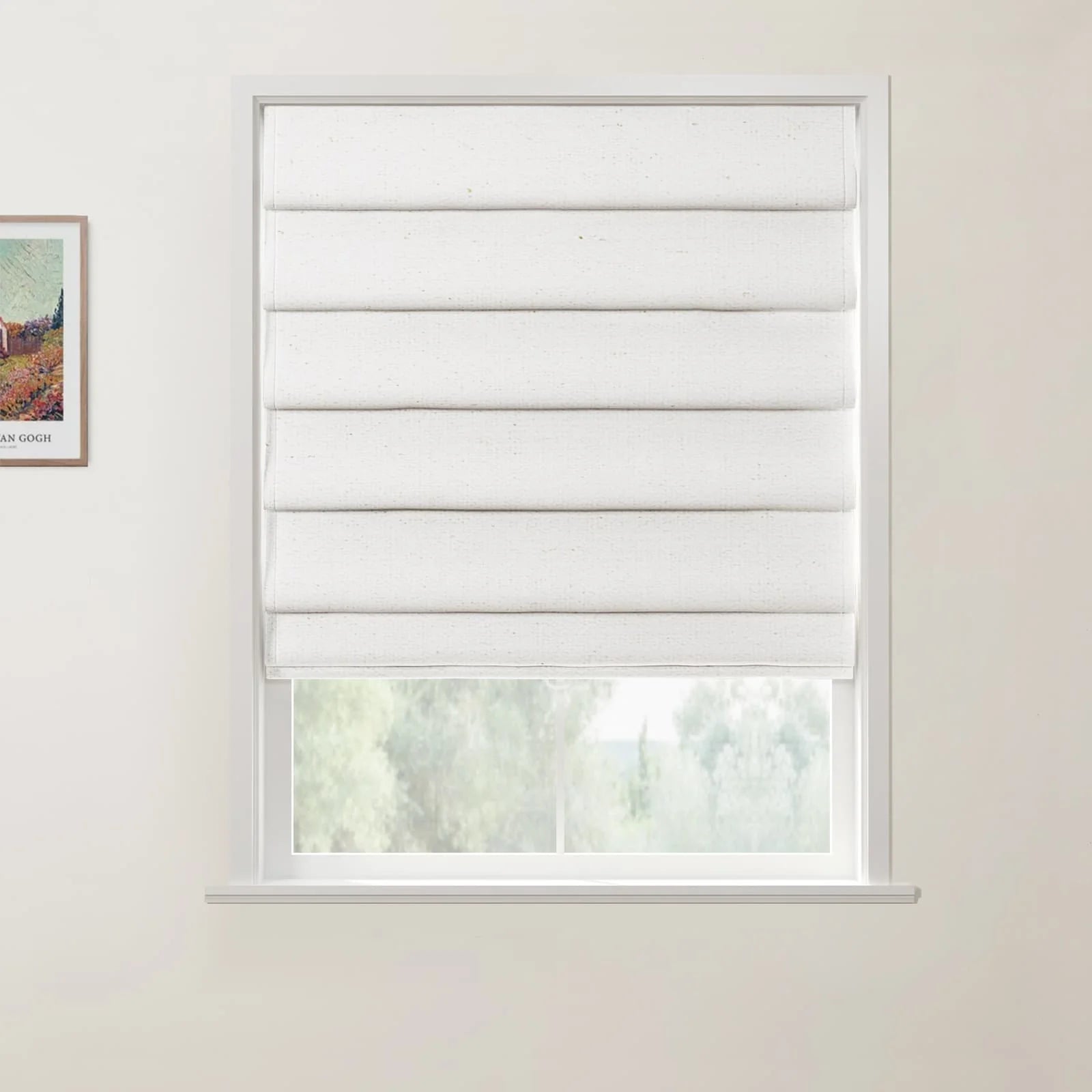 Photograph of a textured white Roman blind covering most of a white window frame, revealing blurry green trees outside, with a framed colorful Van Gogh landscape print on the adjacent light wall