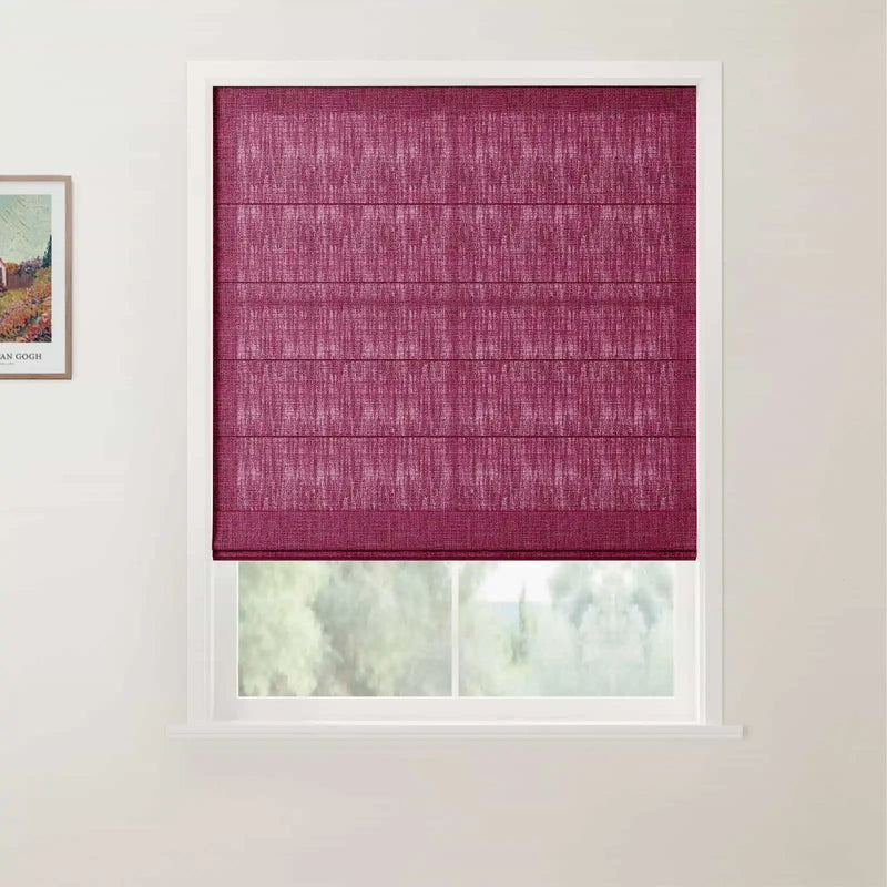Photograph of a window featuring a vibrant magenta textured Roman blind partially lowered revealing a blurred green outdoor scene, with a framed Van Gogh print visible on the adjacent white wall