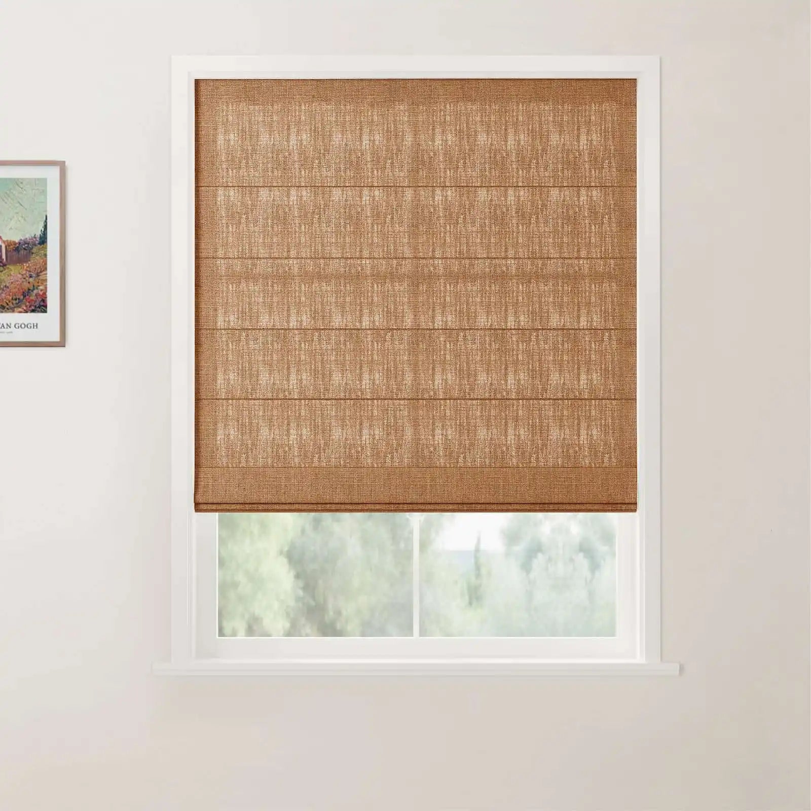 Van Gogh landscape print framed on a white wall next to a window featuring a textured brown woven Roman blind, a white frame, and blurred green trees outside