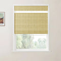 A digital photograph of a bright room featuring a window with a light tan textured linen Roman blind, its sheer top section pulled up to reveal a narrow clear glass strip, alongside a framed Van Gogh print on a white wall overlooking a soft green outdoor landscape