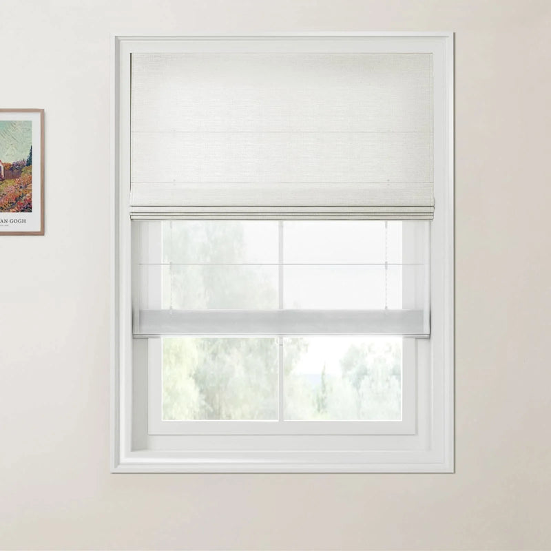 Photograph featuring a framed colorful Van Gogh landscape print next to a window with a partially raised white textured Roman shade, offering a blurred view of green trees outside