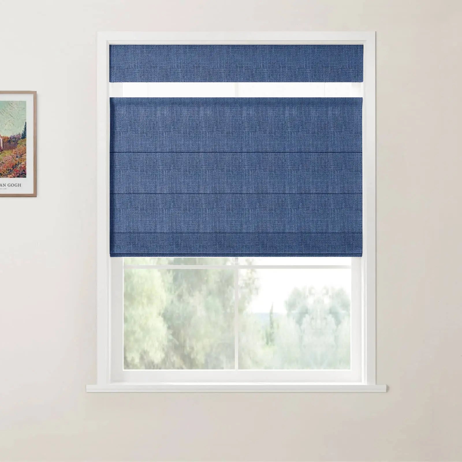 Photograph of a room featuring a white-framed window with a deep blue textured Roman blind, a framed Van Gogh landscape print on the left wall, and a blurred green outdoor view