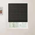 Photograph featuring a framed Van Gogh print beside a window with dark gray textured Roman blinds, white trim, and a subtle view of blurred green trees outside