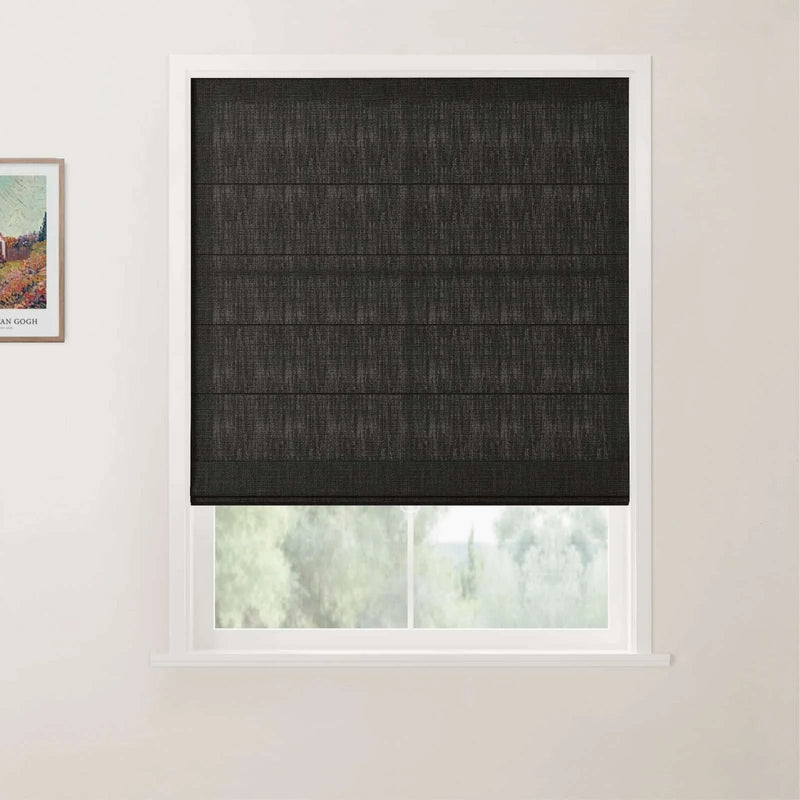 Photograph featuring a framed Van Gogh print beside a window with dark gray textured Roman blinds, white trim, and a subtle view of blurred green trees outside