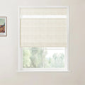 A framed reproduction print of a Van Gogh landscape painting on a white wall next to a window with a light beige textured Roman blind partially open to a blurred green outdoor scene