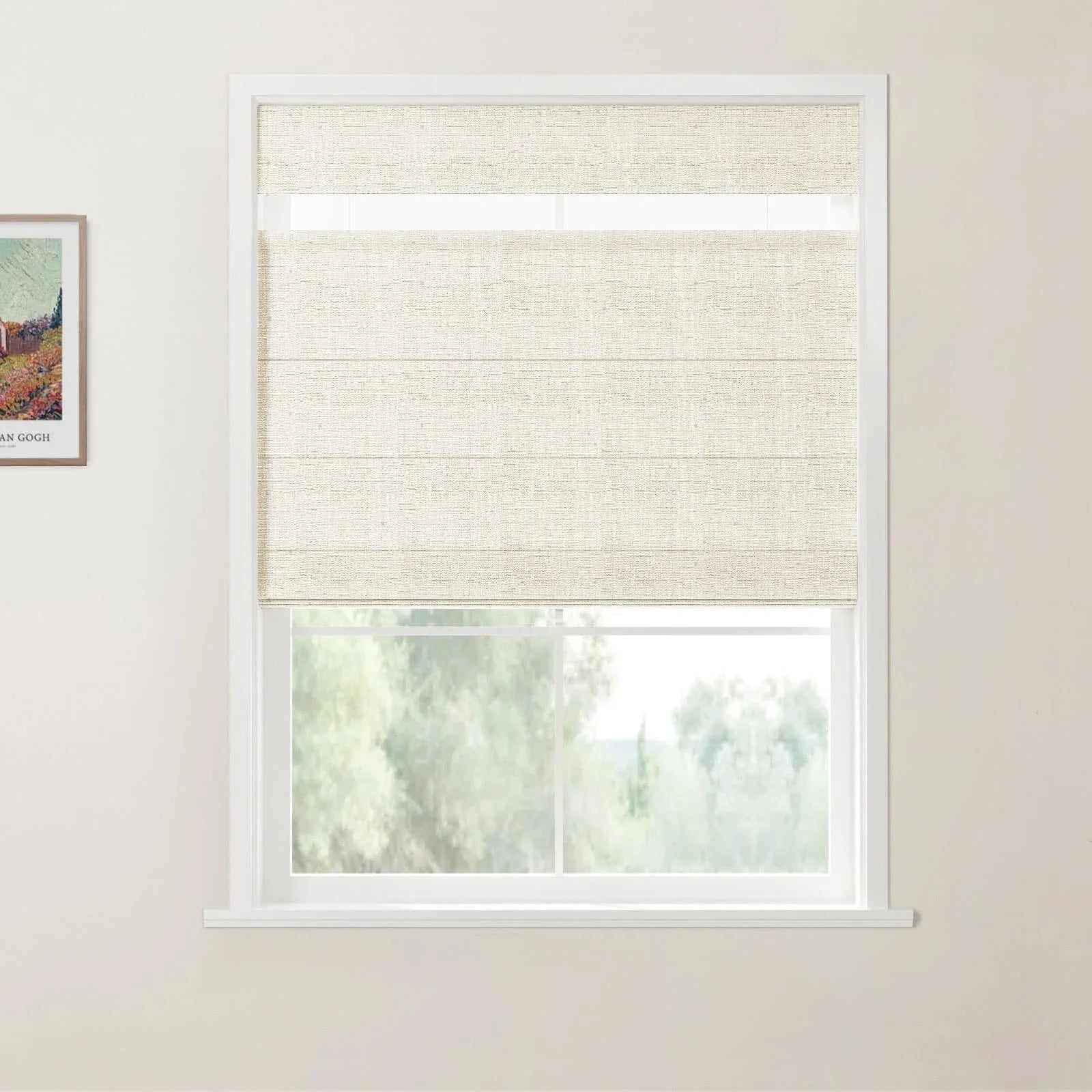 A framed reproduction print of a Van Gogh landscape painting on a white wall next to a window with a light beige textured Roman blind partially open to a blurred green outdoor scene