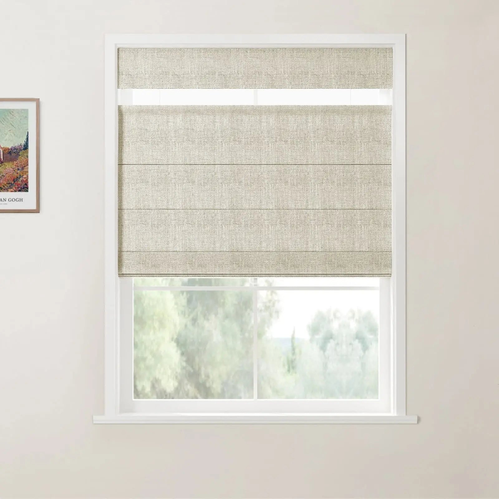 Product photograph of a textured light beige Roman blind on a white window, featuring a blurred green outdoor view and a partially visible framed Van Gogh landscape print