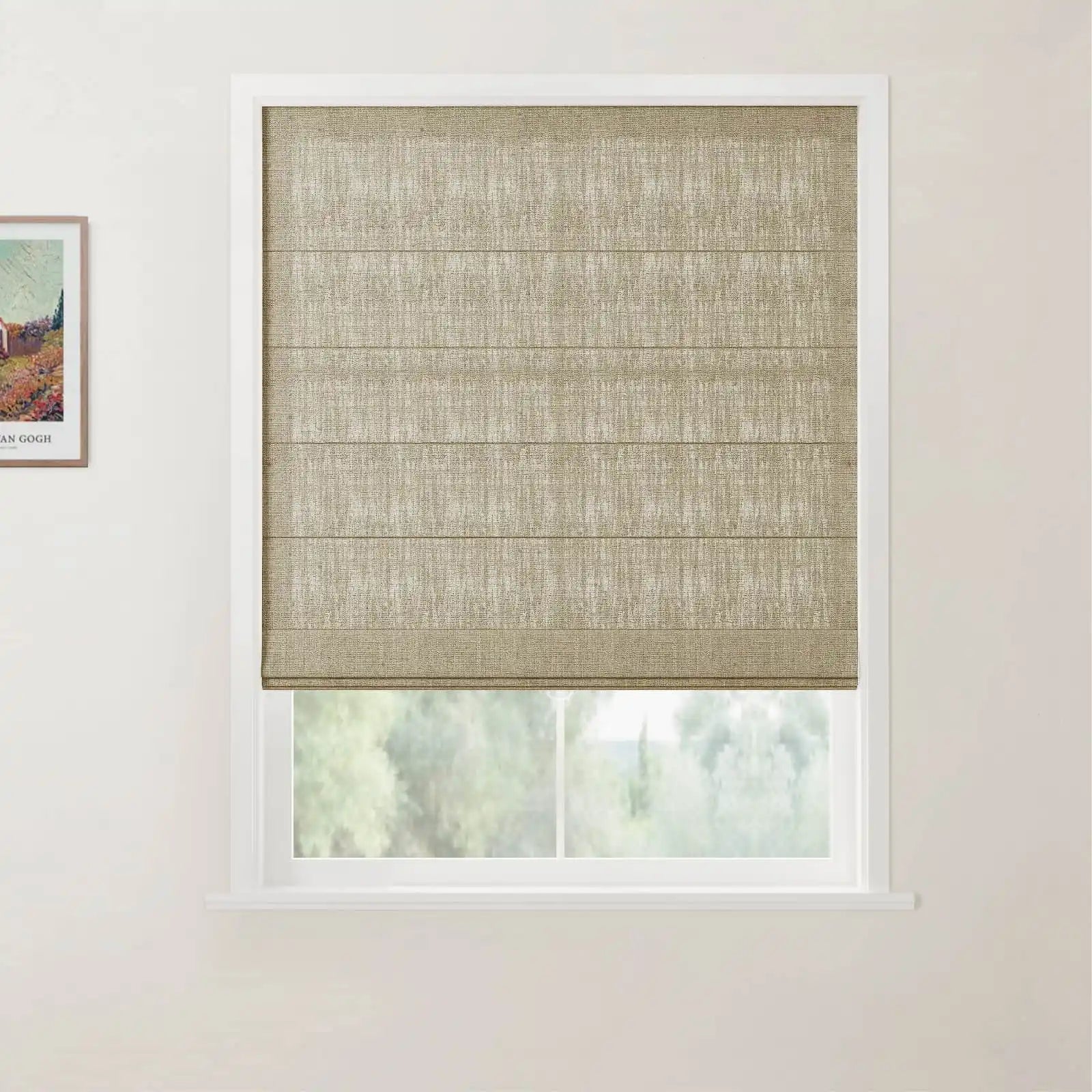 White-framed window showcasing a textured light brown roman blind partially revealing a blurred green outdoor view next to a framed Van Gogh landscape print