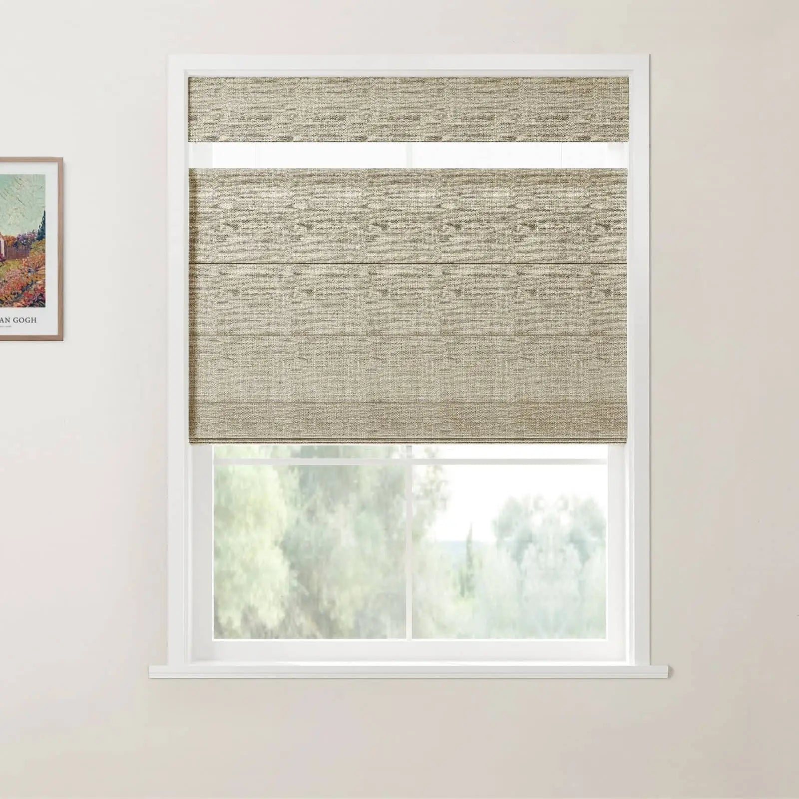 Photograph of a window displaying a textured beige Roman blind partially lowered above a blurry green natural landscape, with a framed Van Gogh print hanging on the adjacent wall