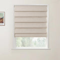 Framed print of a Van Gogh landscape painting on a white wall next to a window with a beige textured Roman shade overlooking blurred green trees