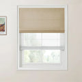Photograph of an interior featuring a window with a tan woven Roman blind and a sheer white bottom-up blind alongside a framed print of Van Gogh's A Wheatfield, with Cypresses on a cream-colored wall
