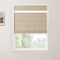 A framed Van Gogh landscape print hangs next to a white-framed window with a textured beige Roman blind partially lowered offering a blurred view of green trees outside