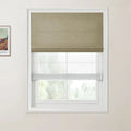 Interior photograph of a window featuring a tan woven top-down bottom-up Roman shade over a sheer white blind, with a framed Van Gogh print on the left wall