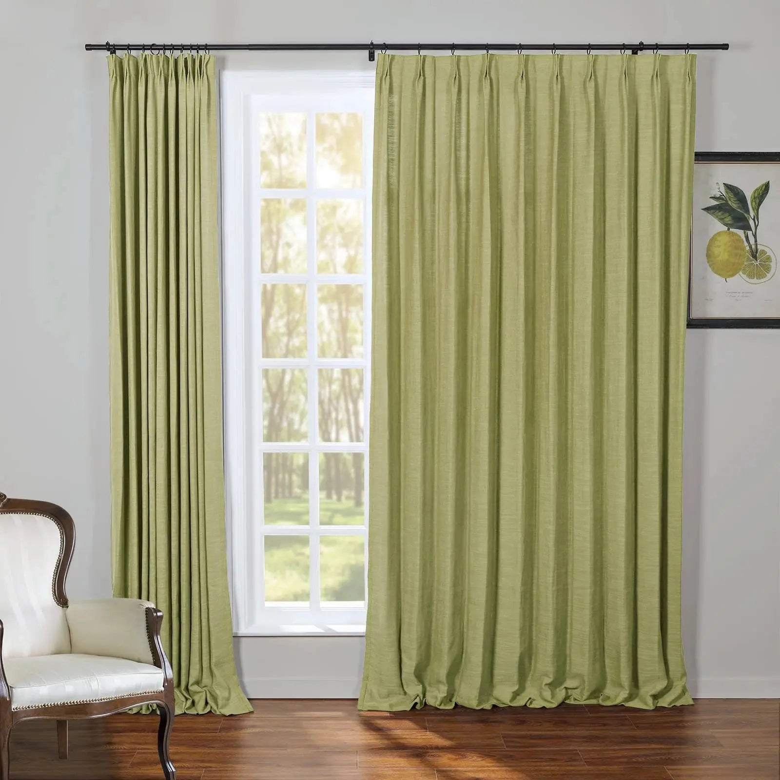 A bright interior room featuring lime green textured curtains on a black rod, a classic white fauteuil arm chair with dark wood and gold studs, and a framed botanical lemon print, overlooking a sunny forest through a grid-paned window