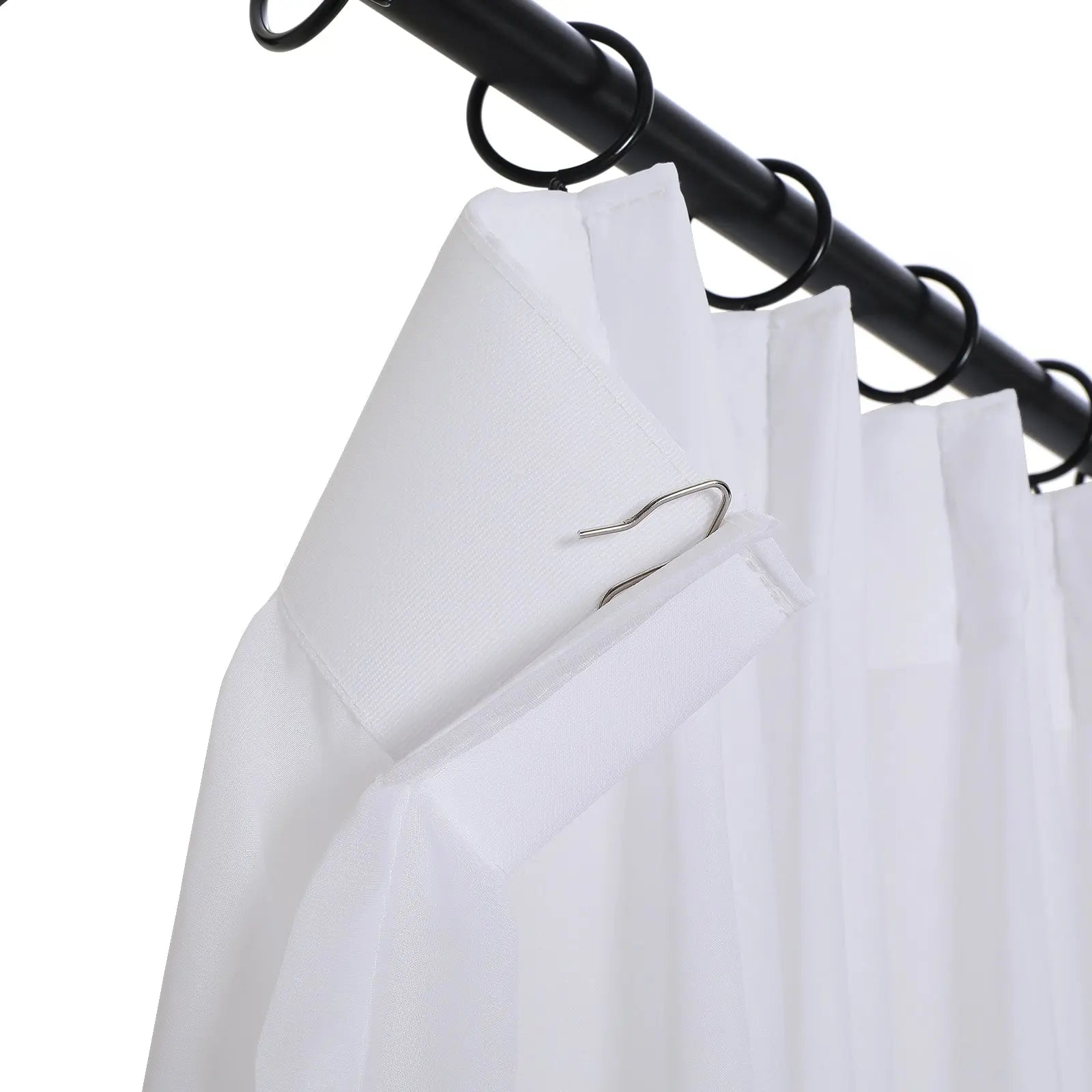 Digital photo of a pleated white sheer curtain with an exposed metal pin hook, suspended by black rings on a black metal rod