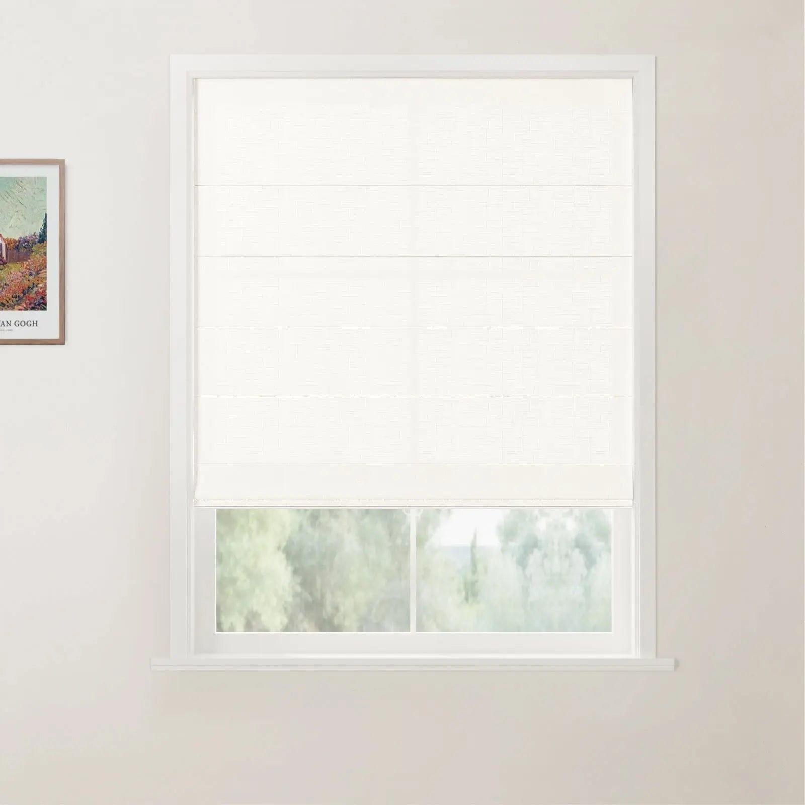 Framed print of a Van Gogh landscape painting hangs on a light wall beside a window with a white woven Roman blind revealing a blurry green outdoor view
