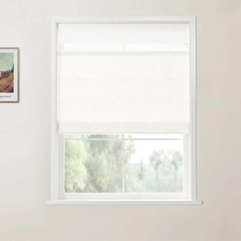 Photograph of a modern room interior featuring a white window frame with a partially lowered textured white roller shade, overlooking a lush green outdoor landscape, with a framed Van Gogh print of a vibrant field on the left wall