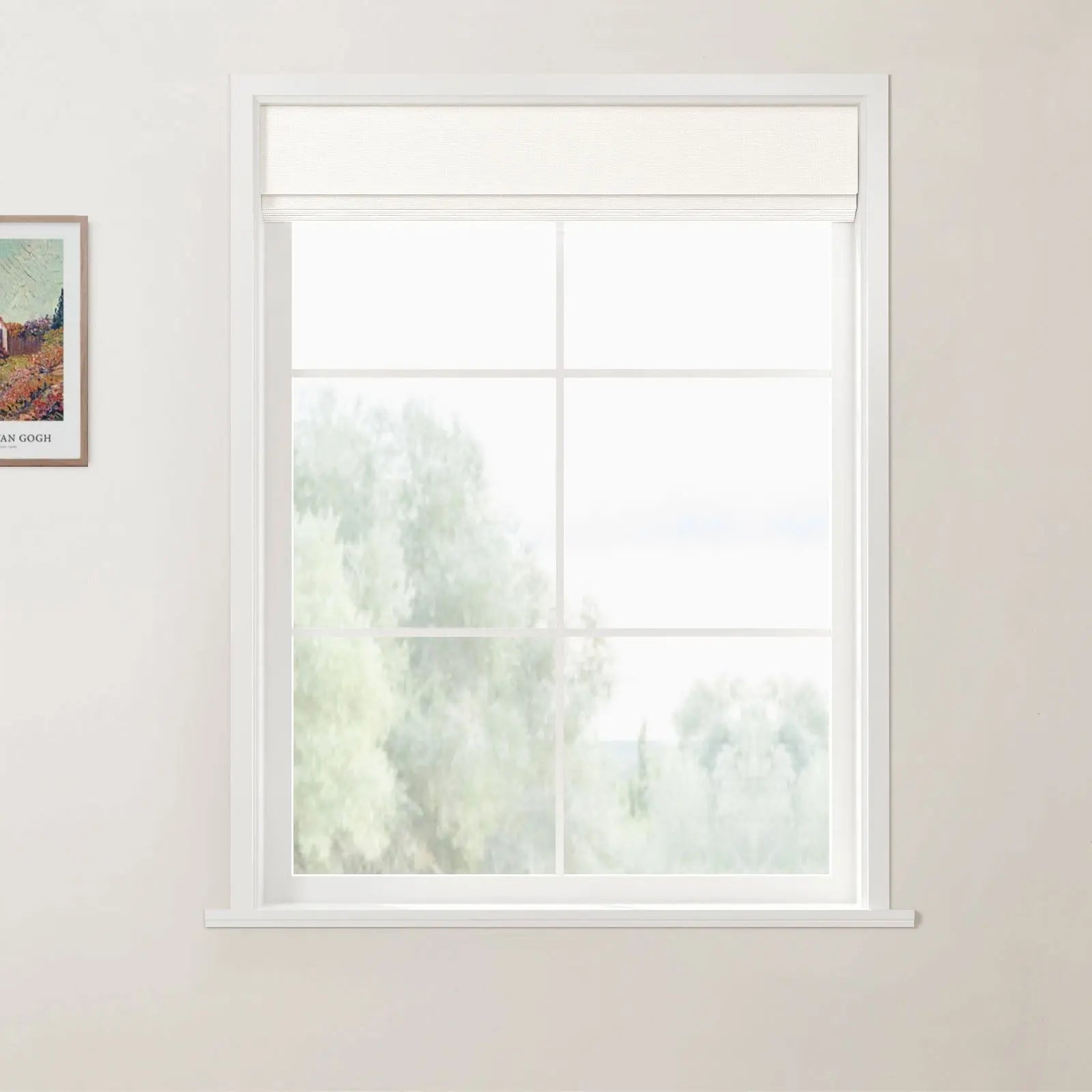 Photograph of an interior white grid window with a partially lowered cream Roman blind, blurry green trees visible outside, and a framed Van Gogh print on the light beige wall