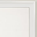 A close-up of a minimalist white linen-like fabric panel within a modern white frame, showcasing its subtle woven texture and a faint horizontal fold