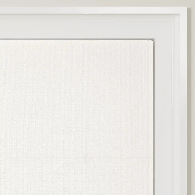 A close-up of a minimalist white linen-like fabric panel within a modern white frame, showcasing its subtle woven texture and a faint horizontal fold