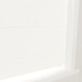 A close-up of off-white textured fabric window blinds featuring horizontal folds and a crisp white frame in a brightly lit interior