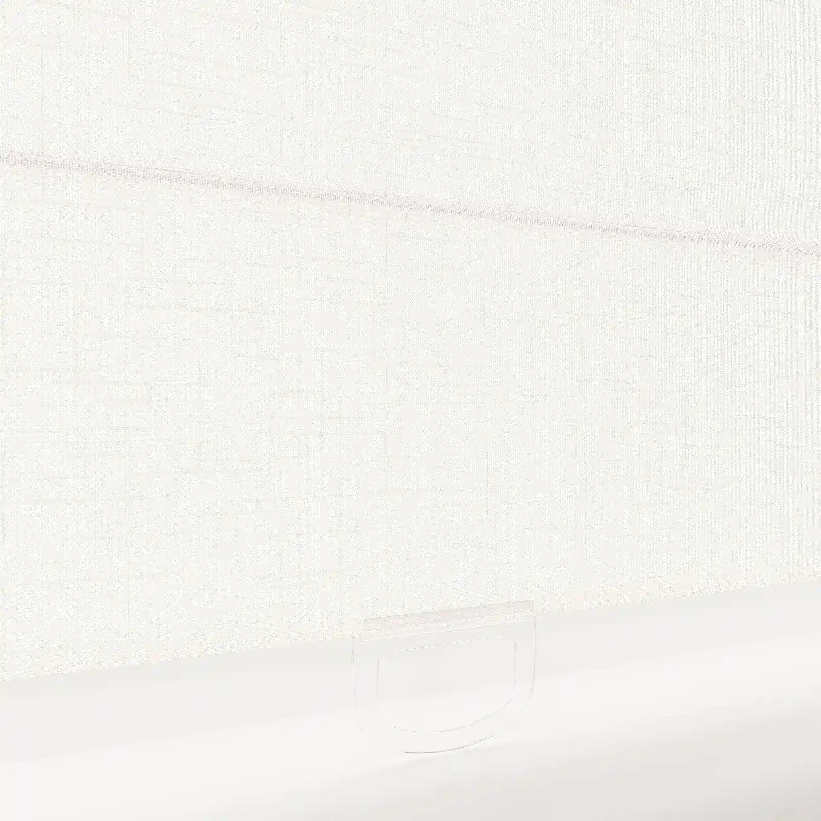 Photograph of a light ivory textured roller blind featuring a subtle horizontal weave and a clear D-shaped plastic pull handle