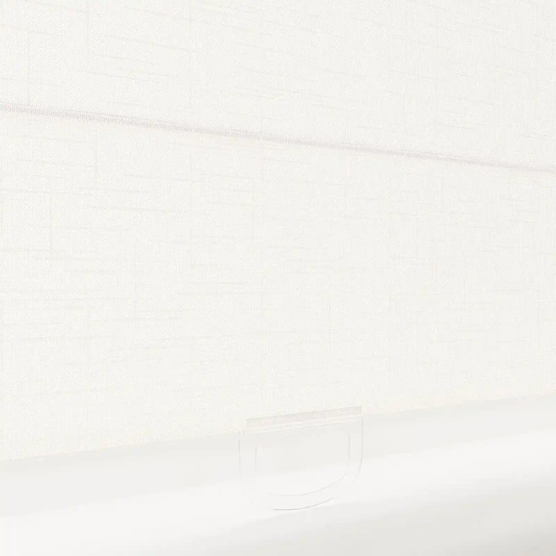 Photograph of a light ivory textured roller blind featuring a subtle horizontal weave and a clear D-shaped plastic pull handle