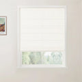 A framed Van Gogh print on a white wall adjacent to a window with a partially drawn white textured Roman blind revealing a blurred green outdoor landscape