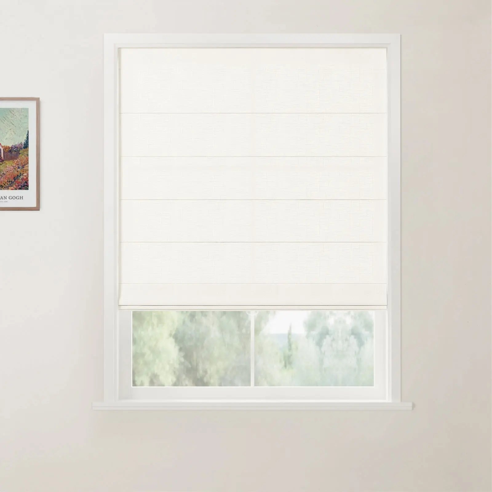 A framed Van Gogh print on a white wall adjacent to a window with a partially drawn white textured Roman blind revealing a blurred green outdoor landscape