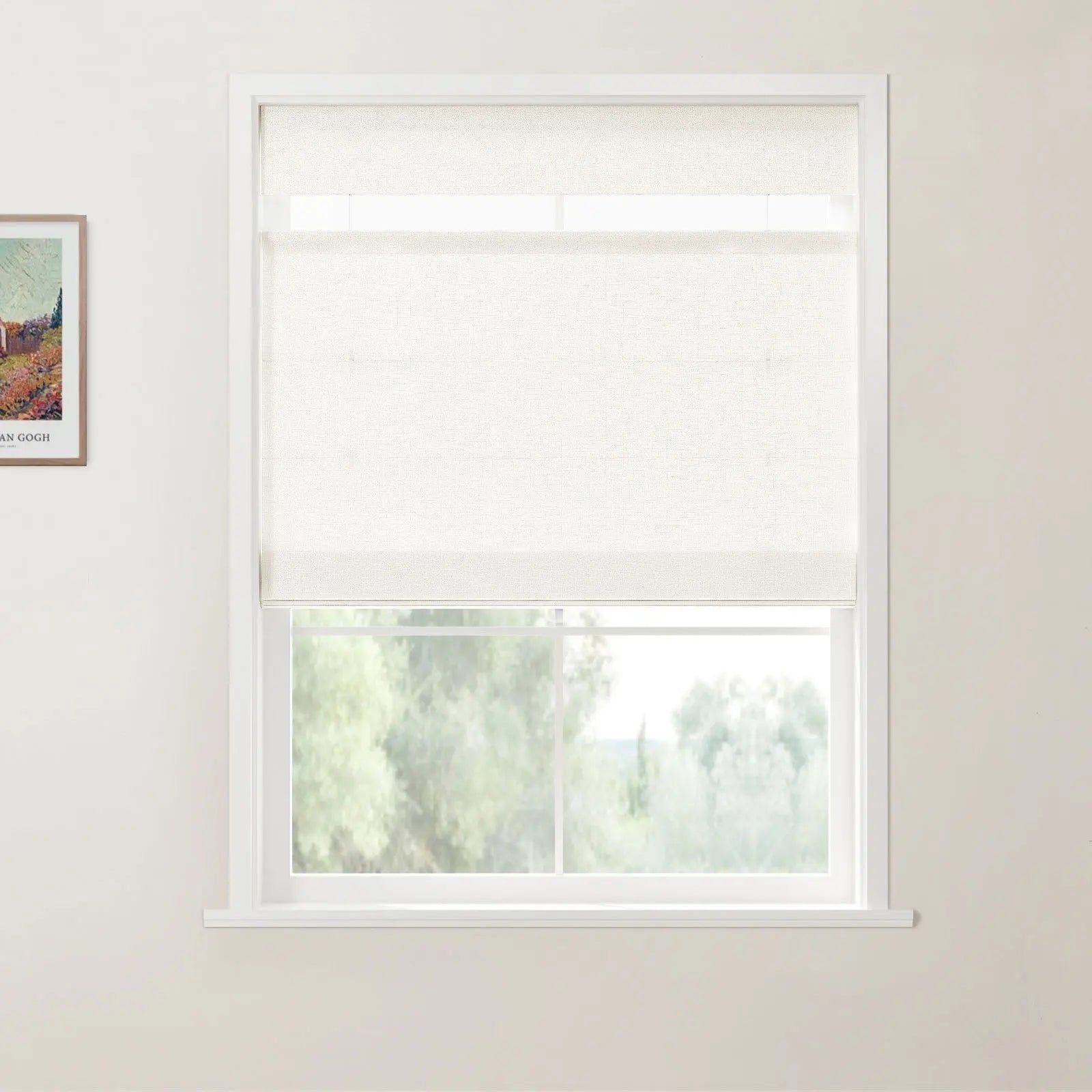 A photograph of a white-framed window with a light beige textured roller blind partially lowered, overlooking a natural scene of blurred green trees, and a framed Van Gogh art print on the left white wall